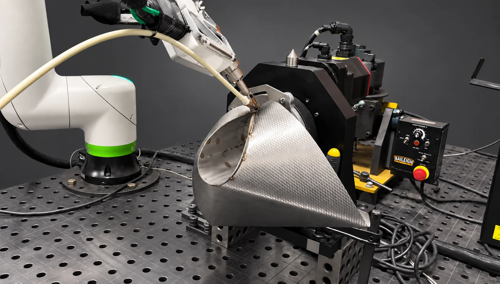 LightBOT welding a stainless food-packaging chute with a rotary positioner
