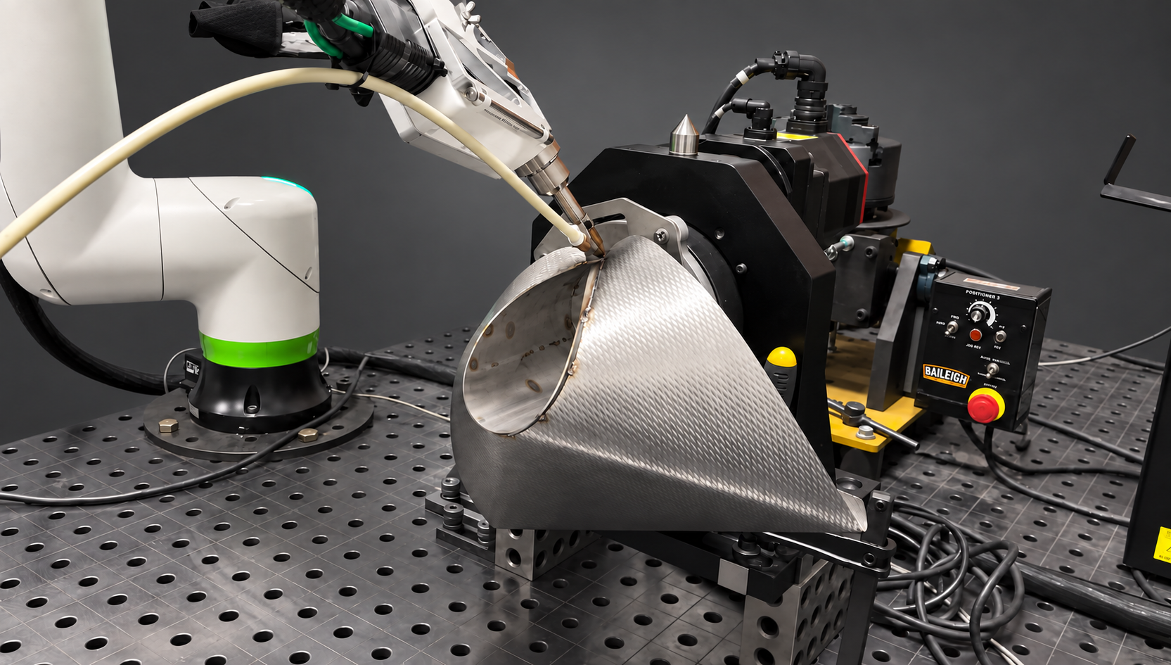 LightBOT welding a stainless food-packaging chute with a rotary positioner